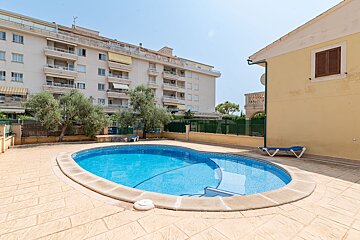 A large swimming pool in front of a building
