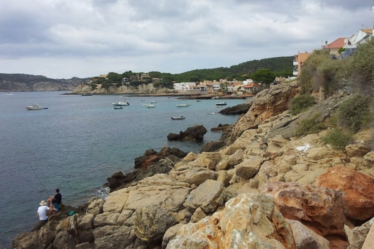 two men fishing off some rocks