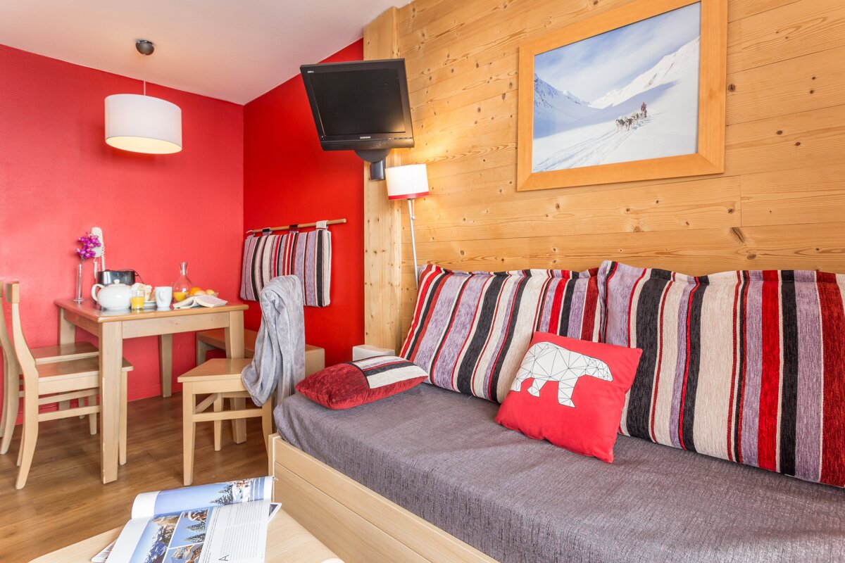 A living room with a couch and a picture on the wall