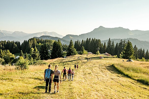 A man and a woman are standing on top of a concrete pillar