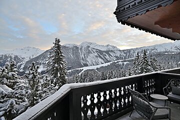 A balcony with a view of snow covered mountains