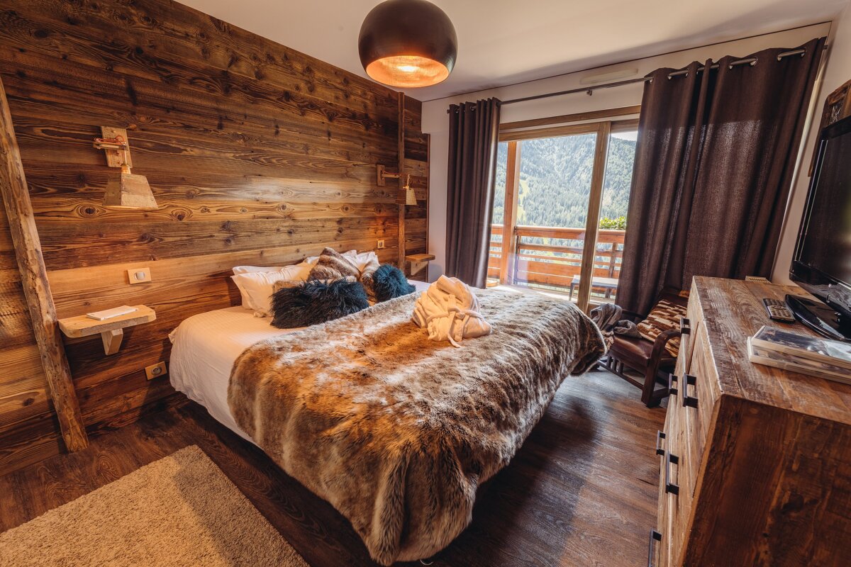 A bedroom with a fur blanket on the bed