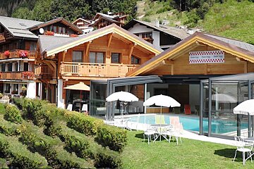 A large house with a swimming pool in front of it