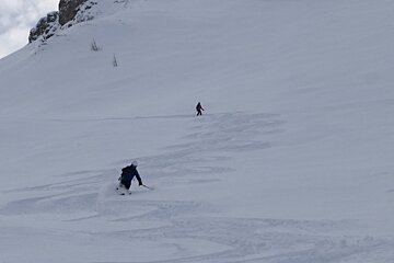 two skiers off piste
