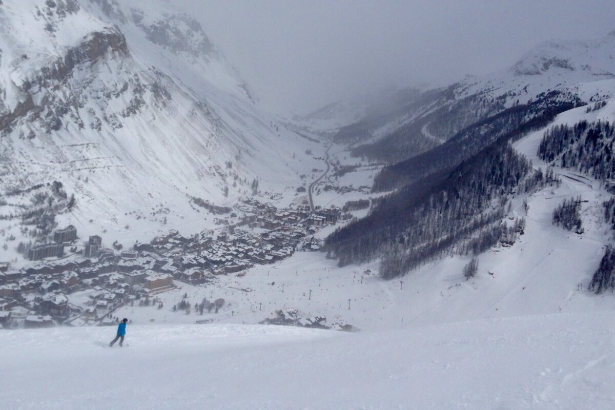 two skiers skiing into val disere