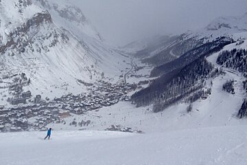 two skiers skiing into val disere