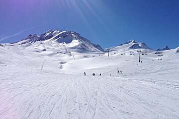 a sunny sky above the pistes of tignes