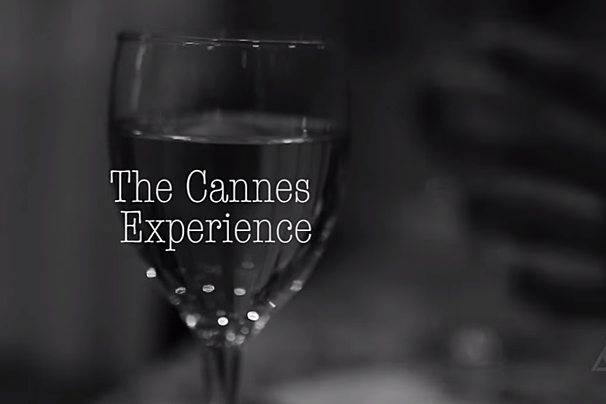 A black and white photo of a wine glass that says the cannes experience