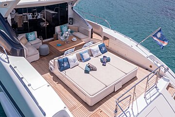 A boat with a large couch and pillows on it