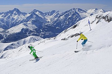 two skiers in bright colours