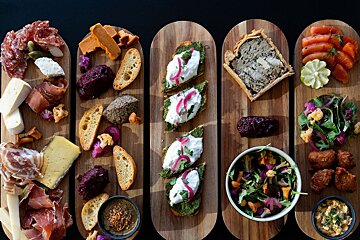 A row of wooden boards with different types of food on them