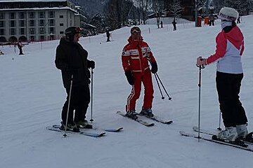 a ski instructor with two students