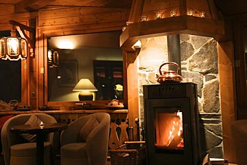 A fireplace with a kettle on top of it