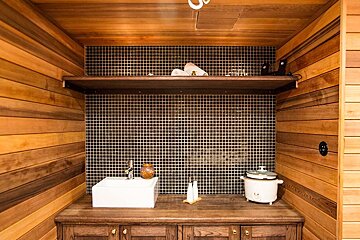 A bathroom with a sink and a shelf above it