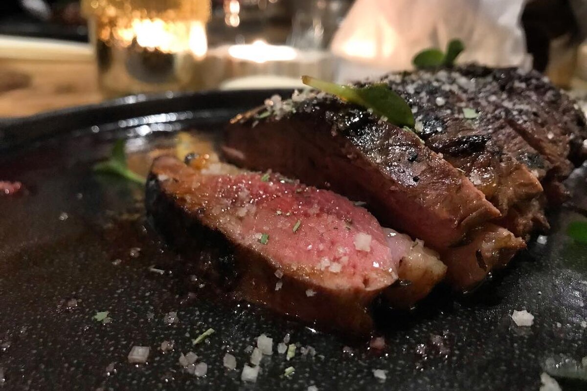A close up of a steak on a black plate