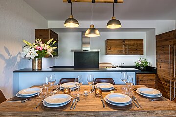 A dining room table with plates and glasses on it