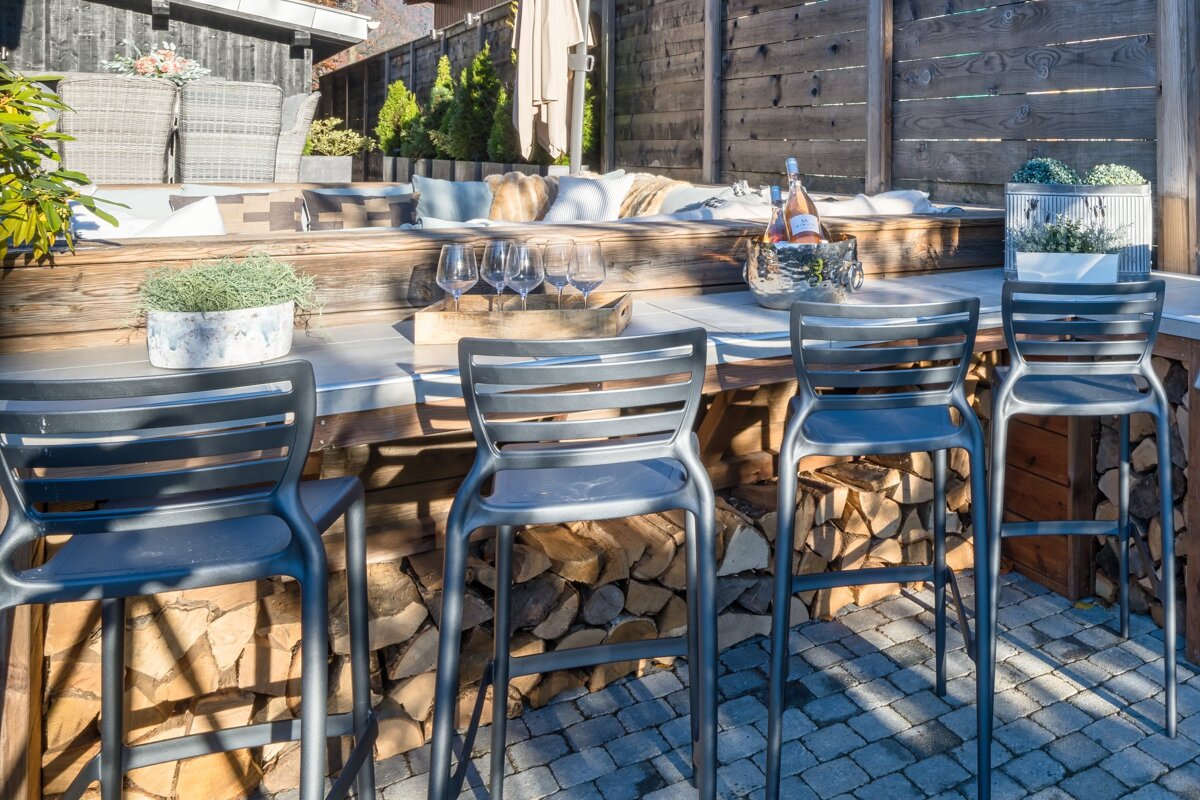 A bottle of wine sits in a bucket on a table