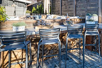 A bottle of wine sits in a bucket on a table