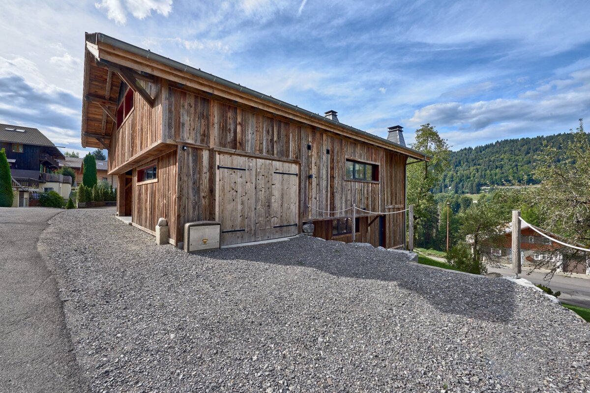 A large wooden building with a rope hanging from the side of it