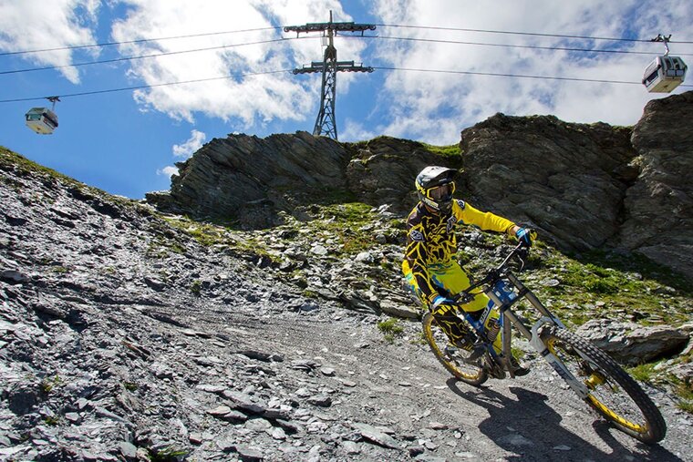 a mountain biker on a red track in la plagne