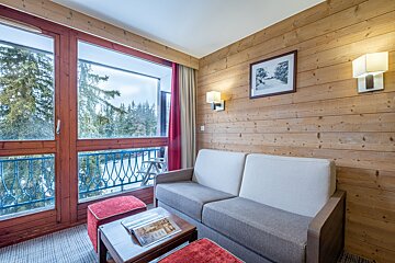 A living room with a couch and a picture on the wall