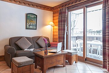 A living room with a picture on the wall that says chamonix