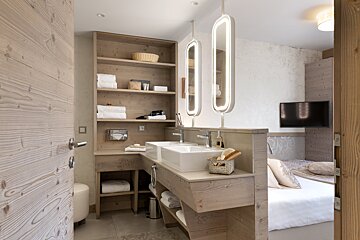 A bathroom with two sinks and two mirrors