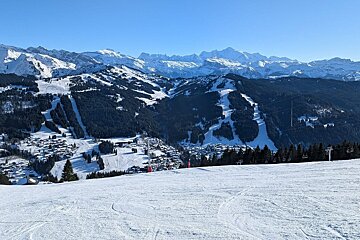 Looking down on a snowy Morzine on a sunny blue sky day