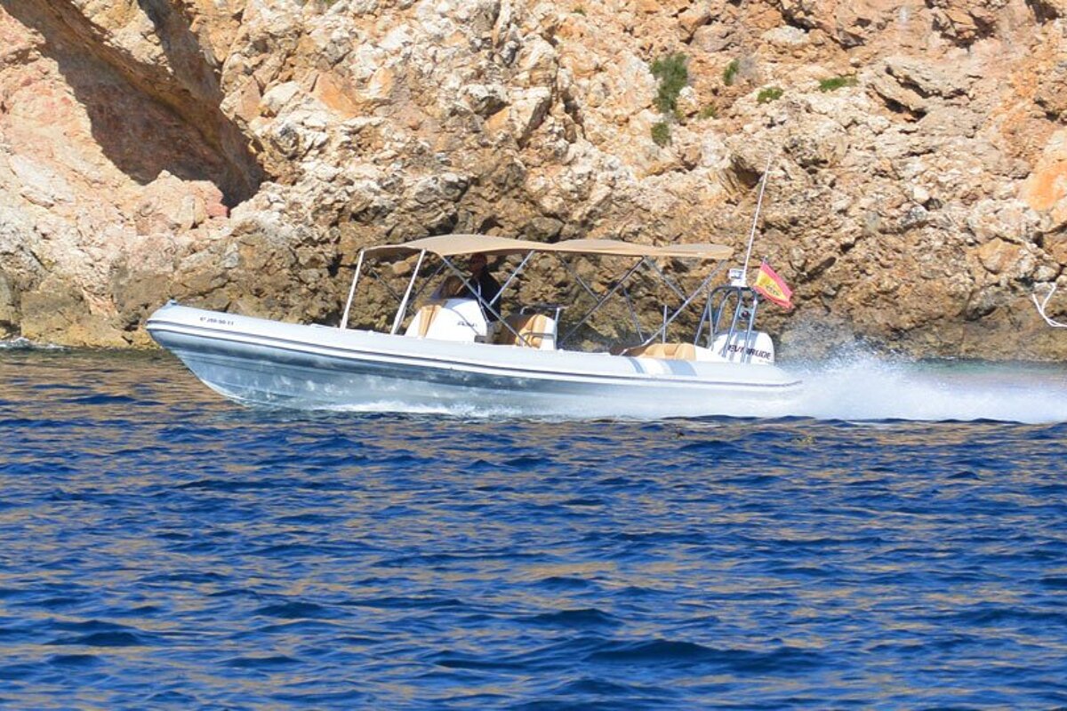 A boat with a canopy on the top of it is floating on the water