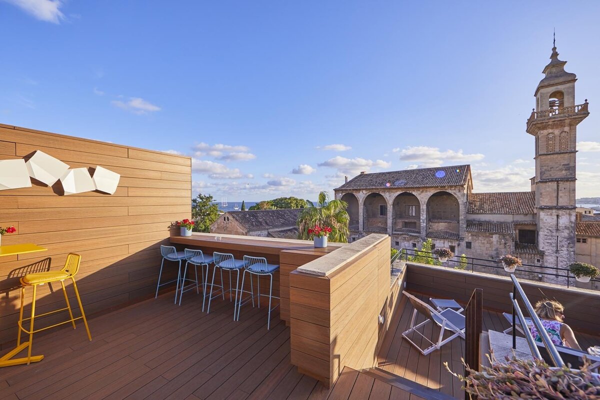 A balcony with a clock tower in the background