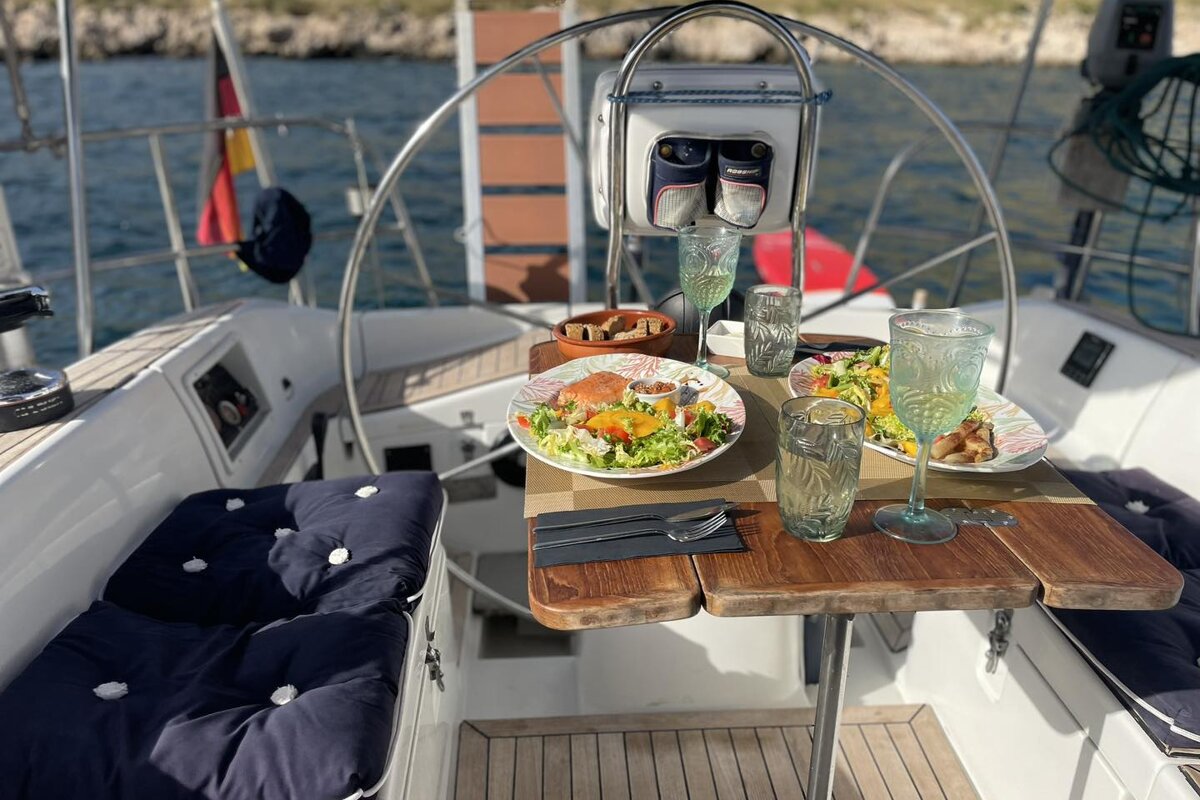 A table on a sailboat with plates of food on it