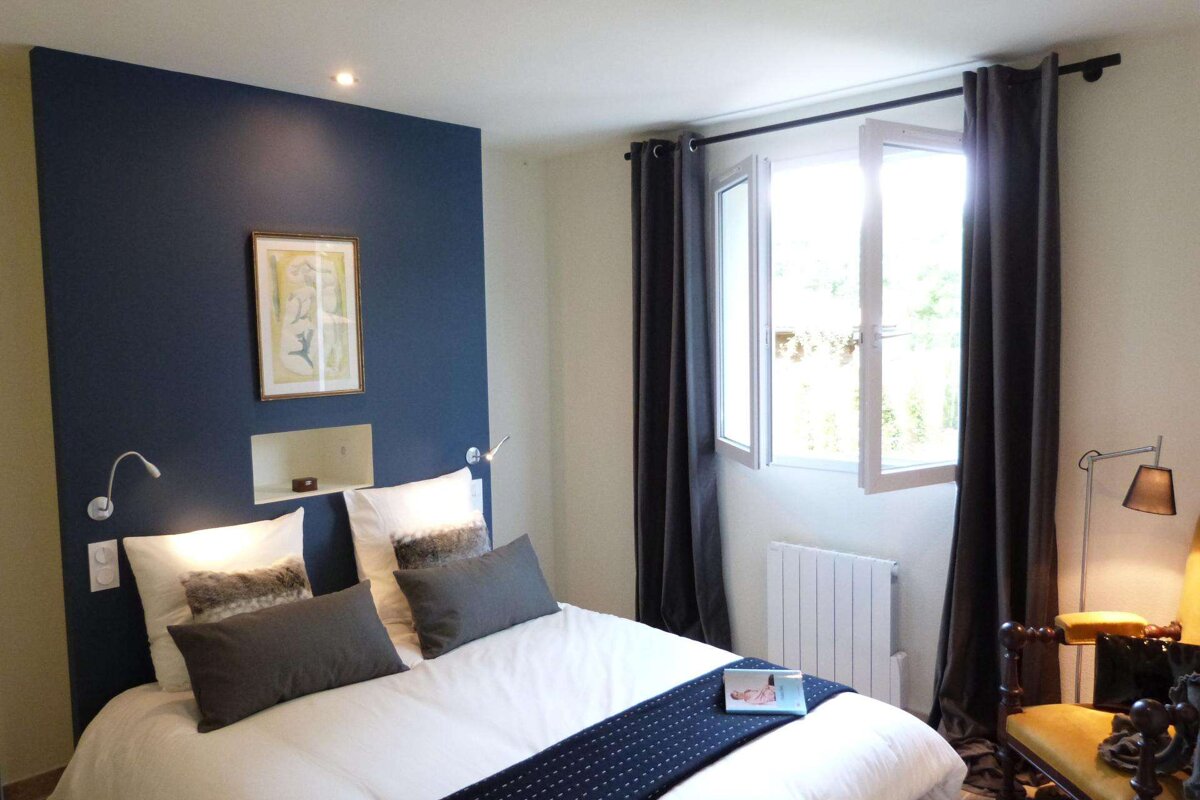 A bedroom with a bed and a book on the bed