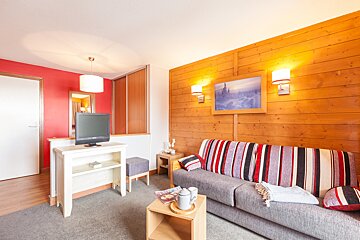 A living room with a couch and a flat screen tv