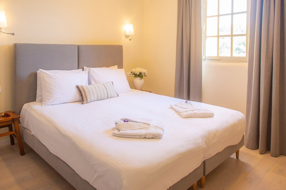 A bedroom with a large bed and a window