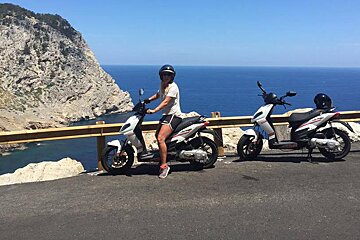 two mopeds parked by the roadside