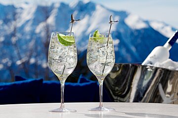 2 glasses with vodka cocktails and silver goose stirrers