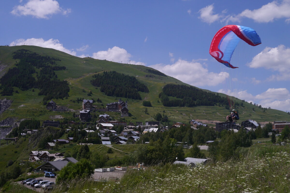 a paraglider folding his wing