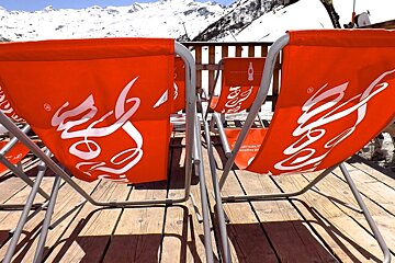 rows or red deckchairs in the sun-empty
