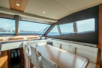 The inside of a boat with a table and chairs