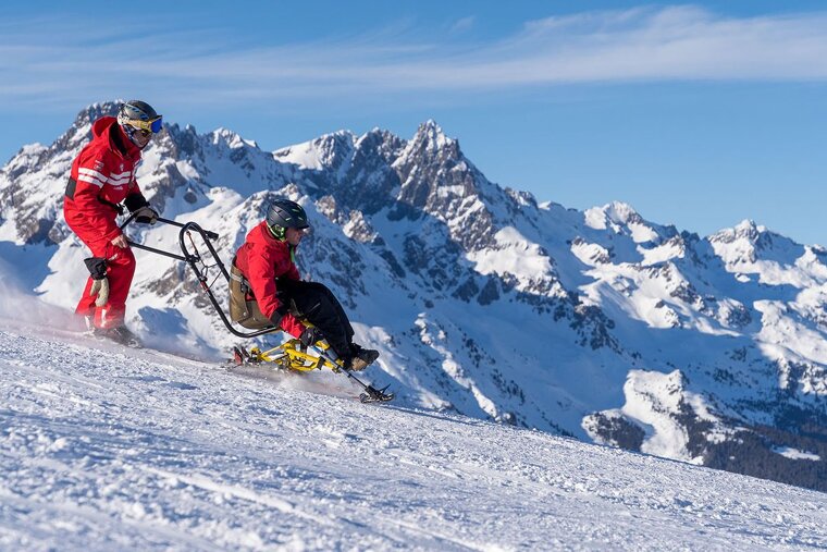A person riding a sled down a snowy mountain