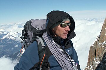 A man wearing a jacket that says rab on it