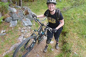 a girl walking with her mountain bike