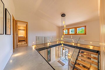 A staircase with a glass railing and wooden steps