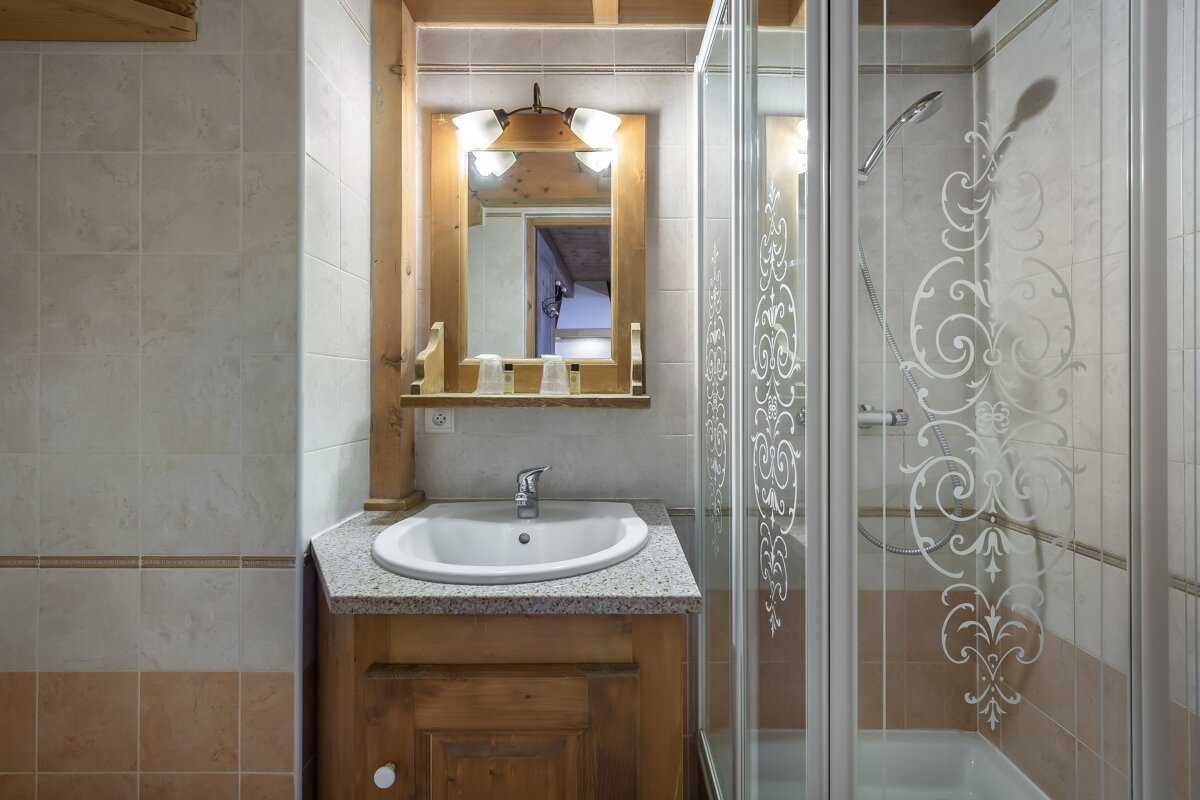 A bathroom with a sink and a walk in shower