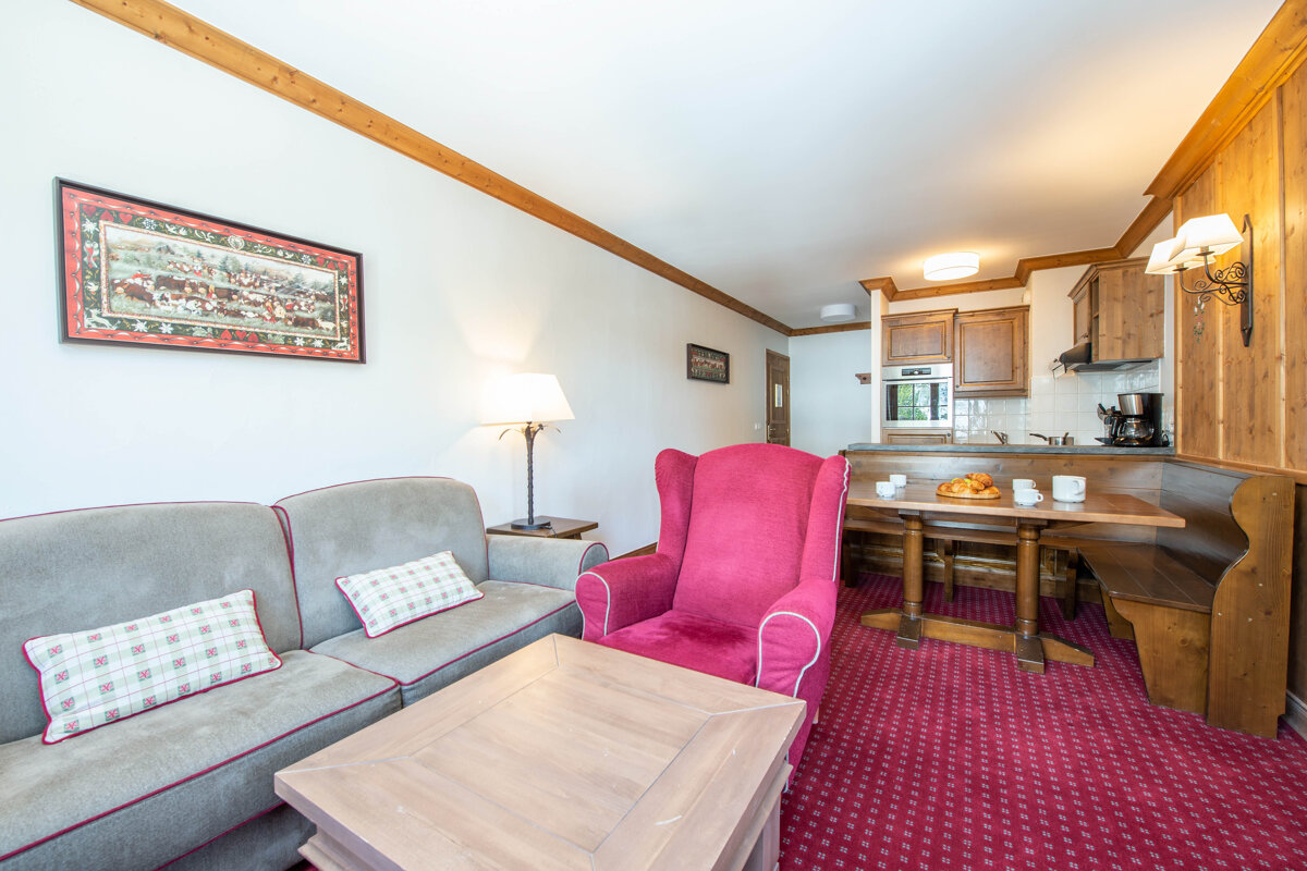 A living room with a couch a chair and a table