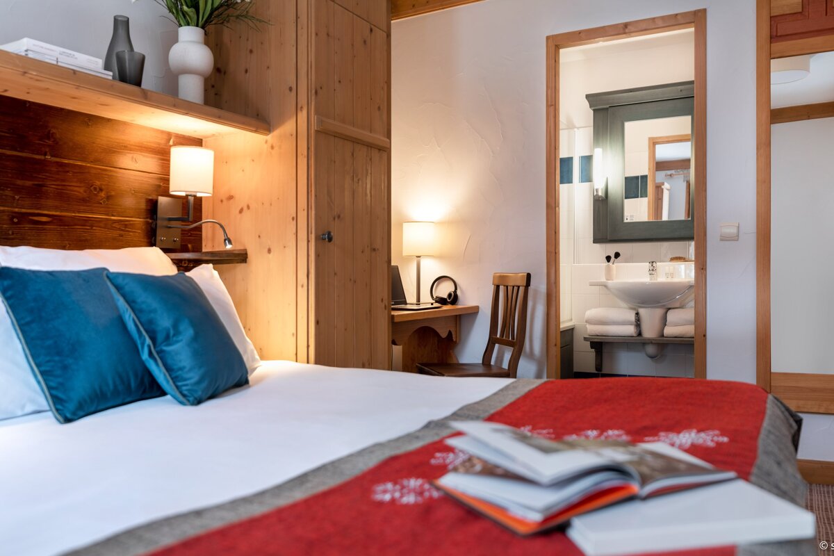 A bedroom with a bed and a book on the bed