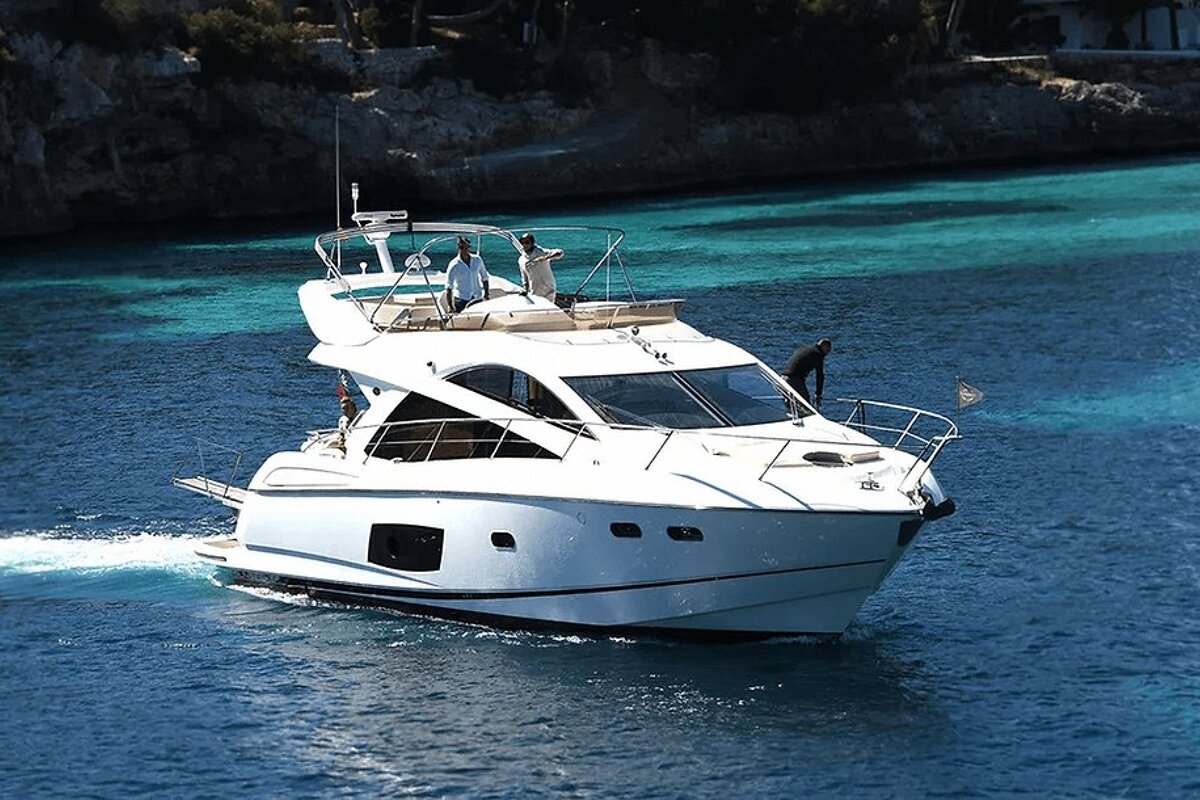 A white boat is floating on a body of water