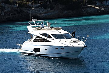 A white boat is floating on a body of water