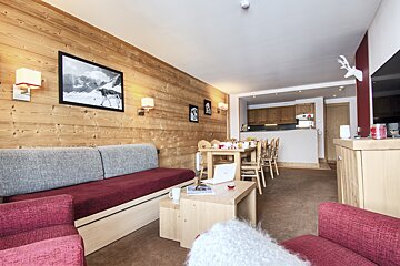 A living room with a couch a chair and a table