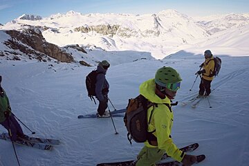 A person wearing a yellow jacket with the word steel on it